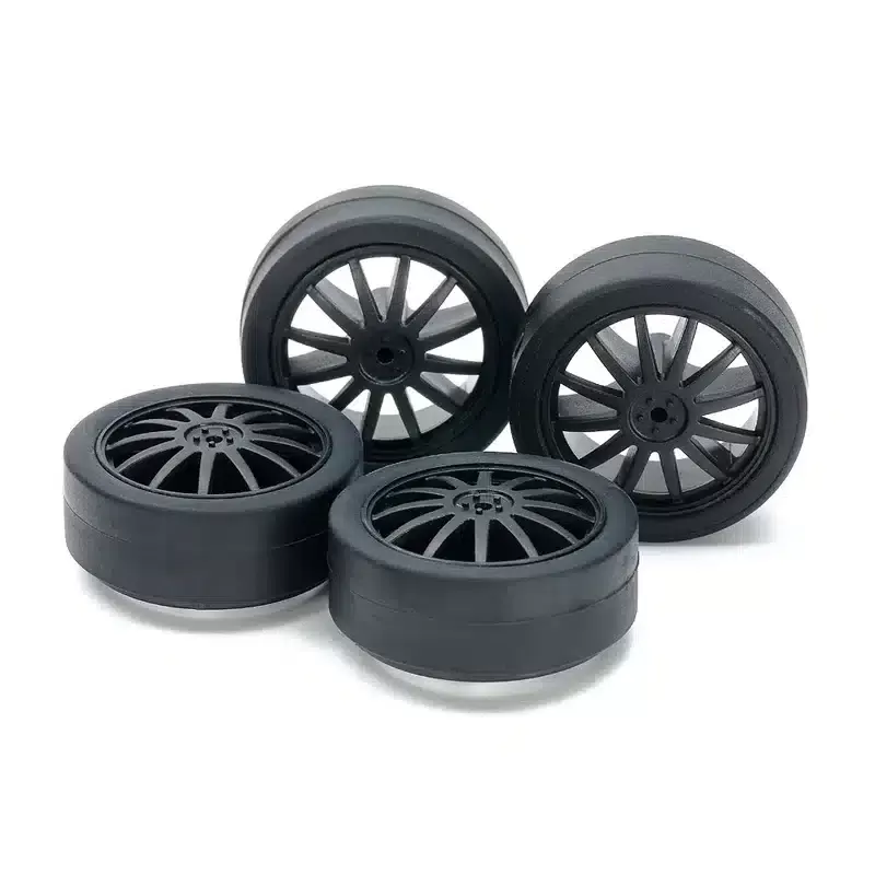 15534.webp TAMIYA 15534 1/32 SMALL DIA. LOW FRICTION LOW-PROFILE TIRES (26mm) & CARBON WHEELS (FIN) - Image 1
